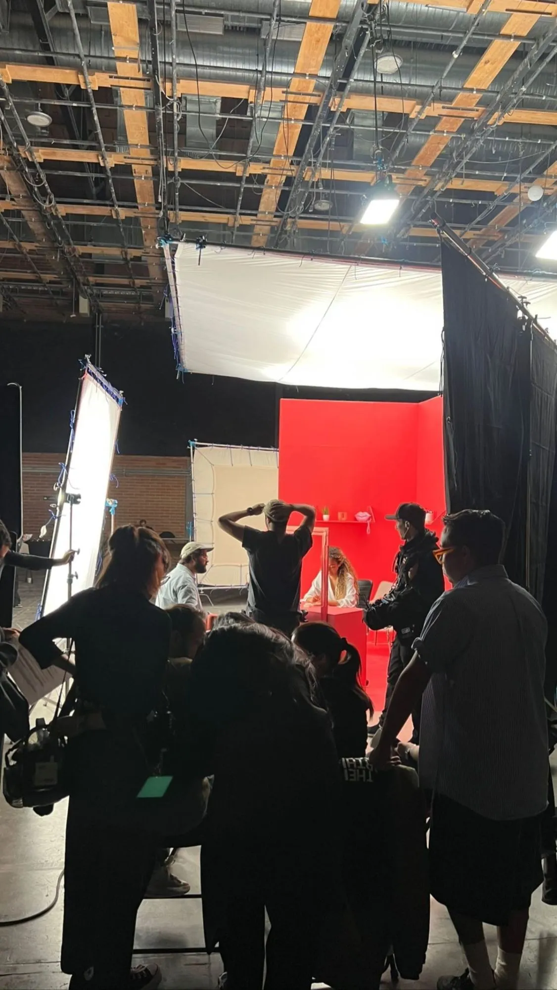 Grand plateau de tournage, décor rouge et équipe